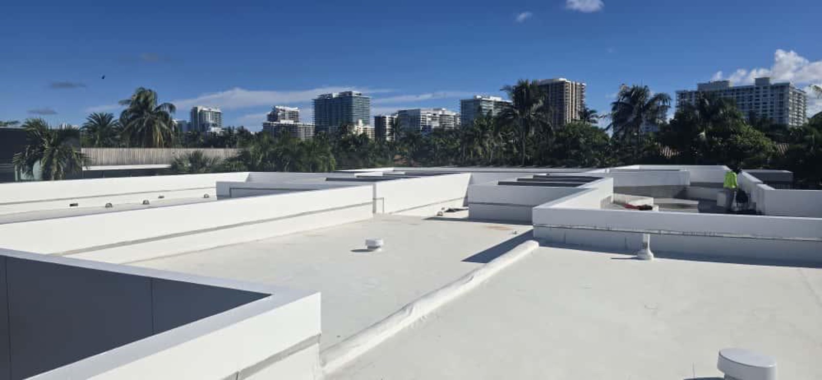 White commercial TPO roof with Miami skyline backdrop