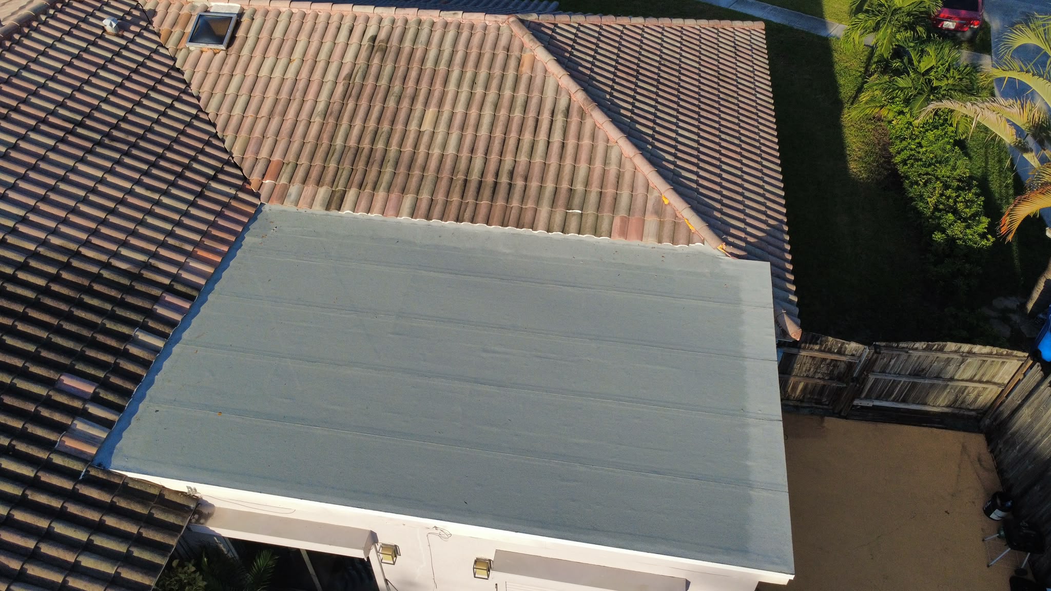 Aerial view of flat roof section tied into a clay tile roof