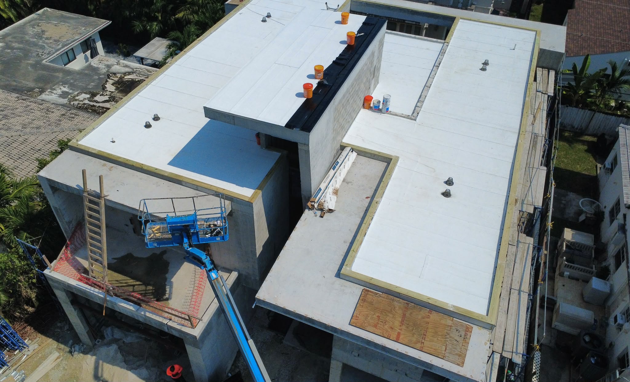 Aerial view of new flat roof membrane on a two-story new construction home